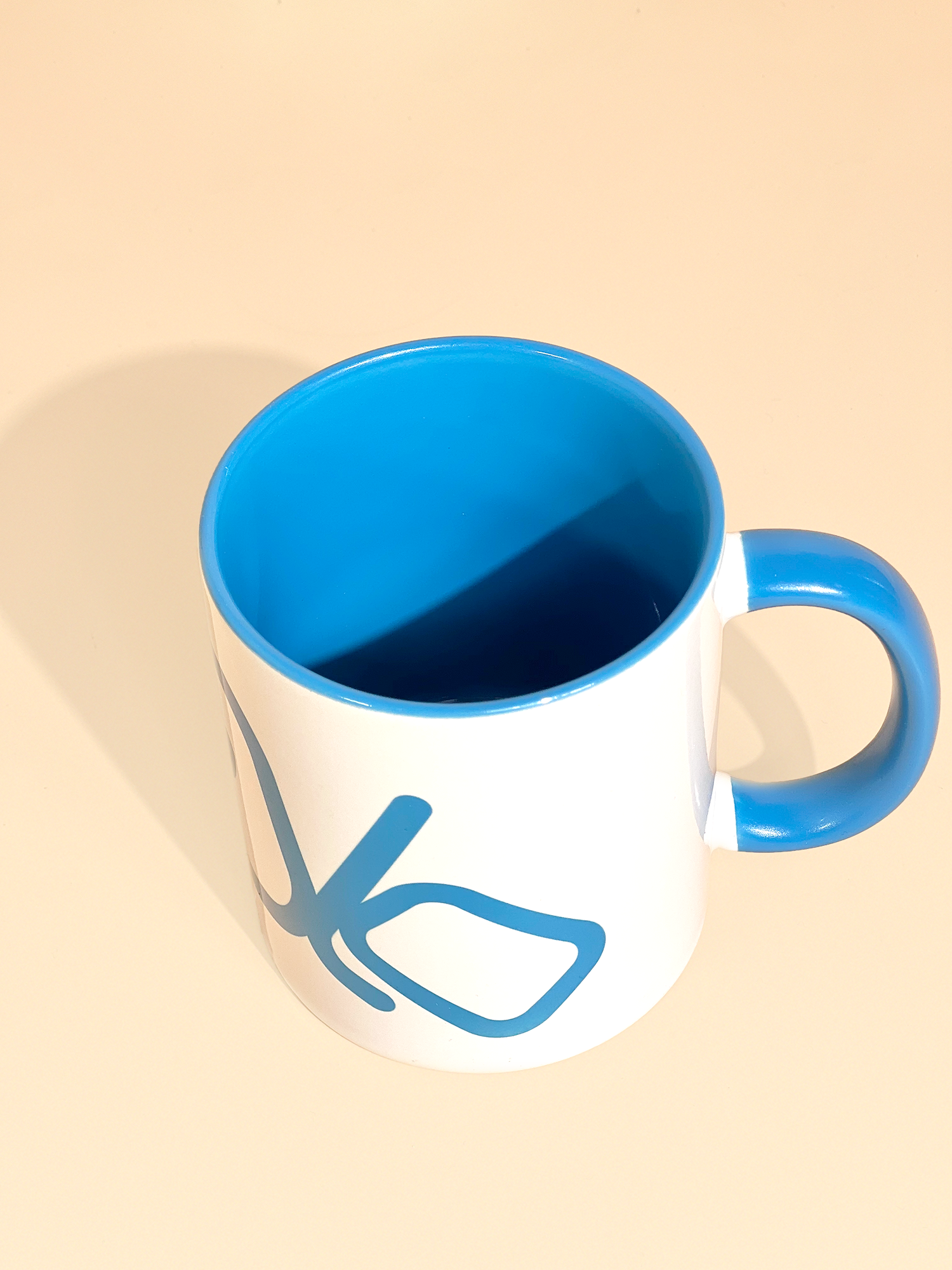 Stylist elegant olaben mug with blue olaben logo in white background outside and blue background inside