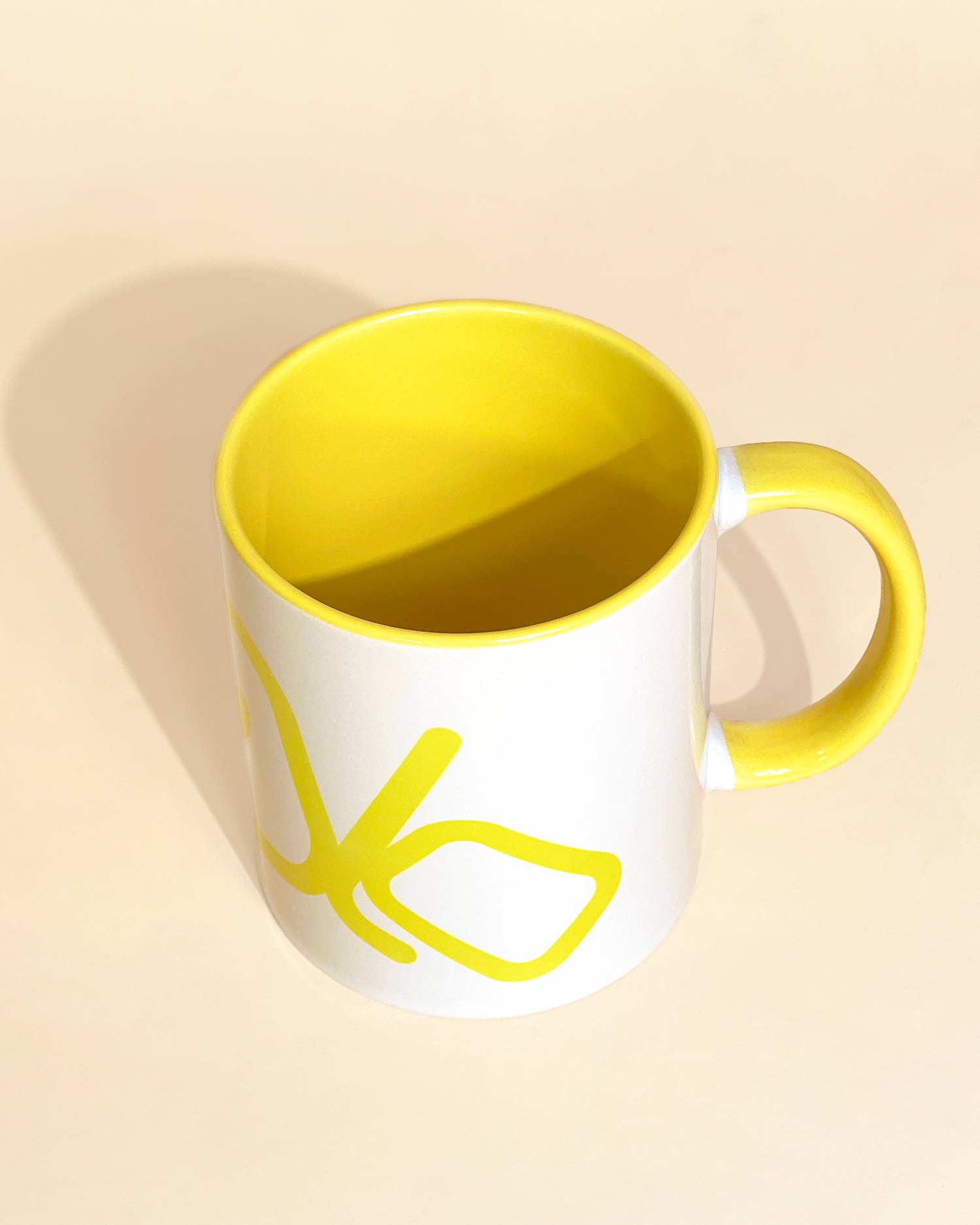 Stylist elegant olaben mug with yellow olaben logo in white background outside and yellow background inside