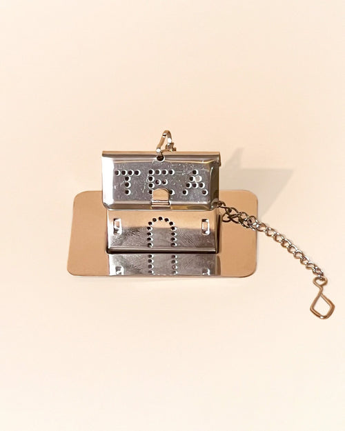 An house shaped infuser in silver color
